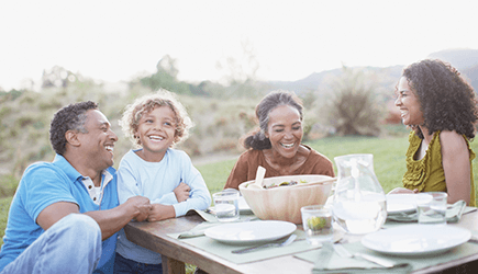 Young Black man looking at his cell phone and smiling